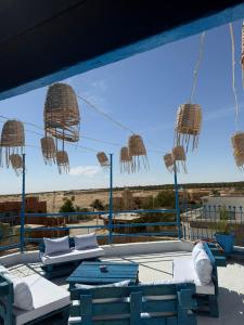 a view of a patio with two beds and chairs at Dar Zénith - Free Breakfast - Résidence Oasis Tozeur in Tozeur +11 photos