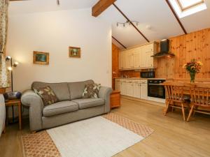 a living room with a couch and a table at The Log Cabin in Gloucester