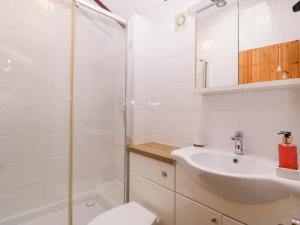 a bathroom with a shower and a sink and a toilet at The Log Cabin in Gloucester +17 photos