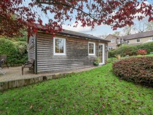 a small log cabin with a yard at The Log Cabin in Gloucester