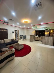 a large living room with a couch and a red rug at Paradis résidence473 in Oran