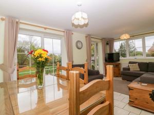 a living room with a couch and a table at Dovecote Cottage in Gloucester