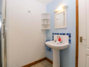 a bathroom with a sink and a shower at Dovecote Cottage in Gloucester +17 photos