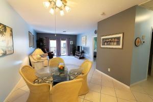 a dining room and living room with a table and chairs at Welcome to Oasis #21 Your Coastal Retreat in Daytona Beach Shores-Walk To The Beach in Daytona Beach Shores