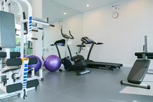a room with cardio equipment in a gym at Minimalist Oasis - Monthly Stay Near Airport, Local Gems & Mall - Minimum Stay 28 Days in Bangkok