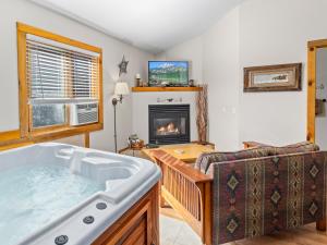 un salon avec un bain à remous et une cheminée dans l'établissement Mountain Shadows Resort, à Estes Park 41 autres photos