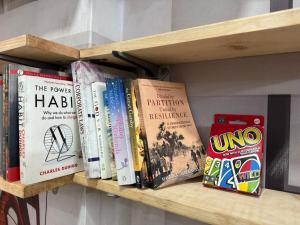 a wooden shelf with books on it at Amritsar Backpackers Hostel in Amritsar