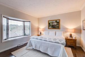 a bedroom with a large bed and a window at Chetola: Robin 1 in Blowing Rock