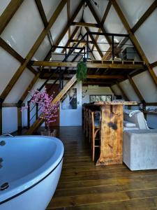a bathroom with a white bath tub and a table at Cabana Pehuen in Santa Maria do Erval