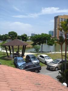 a group of cars parked in a parking lot at Get 2 HomeStay in Melaka