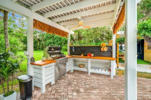 a kitchen under a pergola on a patio at 9BR Heated Pool Hot Tub Sleeps 25 in Largo