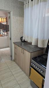 a kitchen with a stove and a counter top at Tulivu homes in Ongata Rongai  +3 photos