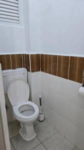 a bathroom with a white toilet in a room at Tulivu homes in Ongata Rongai 