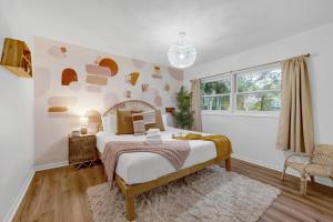 a bedroom with a large bed and a window at 9BR Heated Pool Hot Tub Sleeps 25 in Largo +73 photos