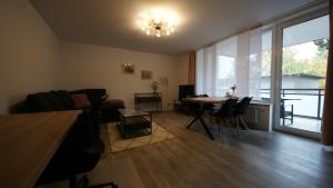 a living room with a couch and a table at Ferienwohnung Gartenstraße in Mühlhausen +4 photos