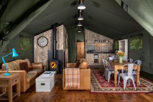 a living room with a couch and a table at Hebog Glamping Lodge in Talybont