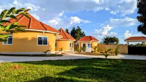 a house with an orange roof at Otogo Guest House in Gulu