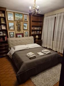 een slaapkamer met een groot bed met twee handdoeken erop bij Gabri House Art gallery b&b in Lucca