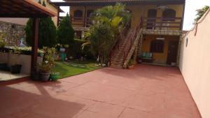 a courtyard of a house with a staircase in it at Pousada Da Restinga in Cabo Frio