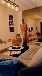 a living room with a couch and a table at Apartman Magic moments Stari Grad in Trebinje