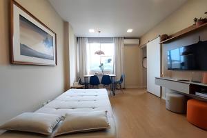 a living room with a couch and a table at Mario401| Loft in Leblon next do Lagoa in Rio de Janeiro