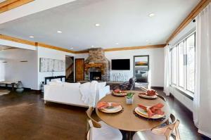 a living room with a table and a couch at Wild Horse Meadows Eden Powder Mtn in Wolf Star