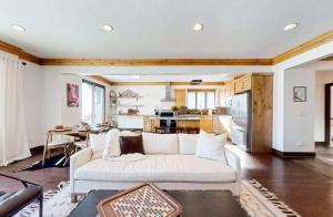 a living room with a white couch and a kitchen at Wild Horse Meadows Eden Powder Mtn in Wolf Star +56 photos