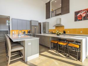 a kitchen with a large island with bar stools at Suncadia 7 Bdrm Home with Amazing View and a Hot Tub in Cle Elum