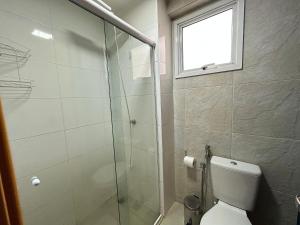 a bathroom with a toilet and a glass shower at iFlat Lozandes Flamboyant Jardim Goiás in Goiânia +7 photos