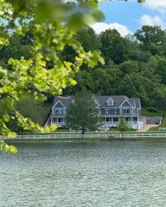 a large house on the shore of a lake at Inns at St Albans in Saint Albans