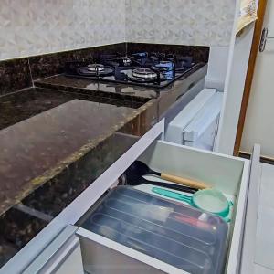 a stove top oven sitting inside of a refrigerator at Apartamento Paraíso Refúgio - Manoah Beach Flats in Maragogi +50 photos