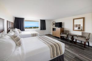 a hotel room with two beds and a window at Dune Crest Hotel in North Truro
