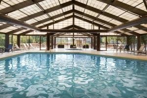 an indoor swimming pool with a large ceiling at Madison Marriott South in Madison