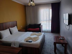 a hotel room with a bed with towels on it at Ay suit in Esenyurt +4 photos