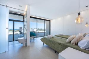 a bedroom with a bed and a view of the ocean at Villa Dominica in Páteo +36 photos