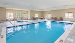 a large swimming pool with chairs and tables at Staybridge Suites Canton by IHG in North Canton