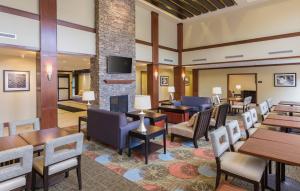 ノース・カントンにあるStaybridge Suites Canton by IHGのホテルのロビー(テーブル、椅子、暖炉付)