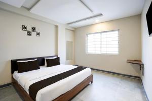 a bedroom with a large bed and a window at Hotel O Eternity Stays in Harsola