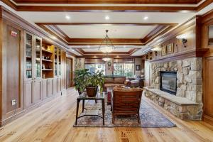 an open living room with a stone fireplace at Eagle Springs East 304: Josephine's Suite in Solitude