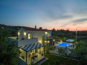 a villa with a swimming pool at night at Holiday Home in Ždrelac with Seaview, Terrace, Air condition, WIFI (4652-1) in Ždrelac