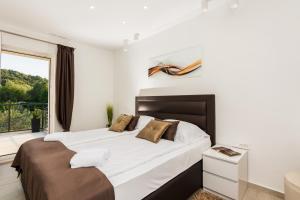 a bedroom with a large bed and a large window at Holiday Home in Ždrelac with Seaview, Terrace, Air condition, WIFI (4652-1) in Ždrelac +71 photos