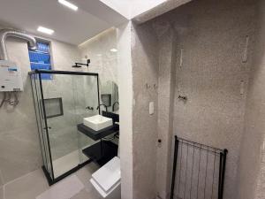 a bathroom with a glass shower and a sink at 360 SUH Copacabana 139 in Rio de Janeiro +2 photos