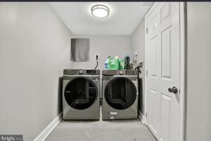 een wasruimte met wasmachine en droger bij Room to Rent in Baltimore +3 foto's
