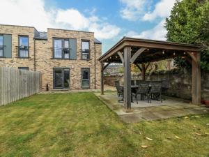 a patio with a table and chairs in a yard at 14 Old Market Place in Bonnyrigg