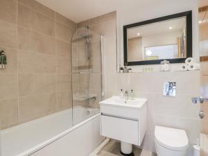 a bathroom with a shower toilet and a sink at 14 Old Market Place in Bonnyrigg +28 photos