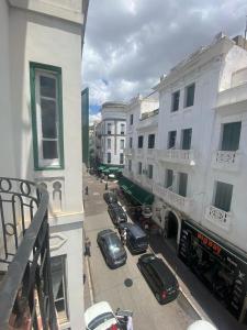 a view from a balcony of a street with cars at Charming apartment heart of Medina 2 min Royal Palace Tetouan 2BR, Balcony in Tetouan +3 photos
