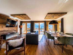 a living room with a dining room table and chairs at Appartement cosy en duplex, 8 pers, parking, Les Gets - FR-1-598-59 in Les Gets