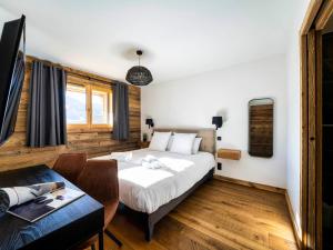 a hotel room with a bed and a table at Appartement cosy en duplex, 8 pers, parking, Les Gets - FR-1-598-59 in Les Gets
