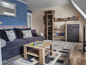 a living room with a couch and a table at Ferienwohnung Sabine in Koblenz