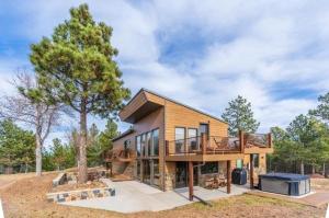 a large wooden house with a deck and a grill at Ponca Lode Retreat in Keystone